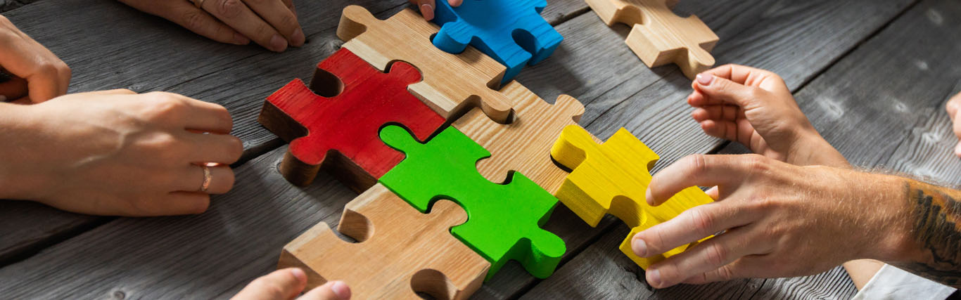 Group of people assembling a puzzle