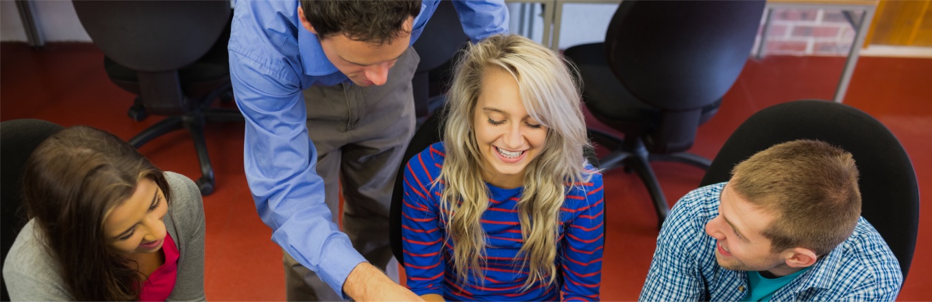 Teacher helping students with projects